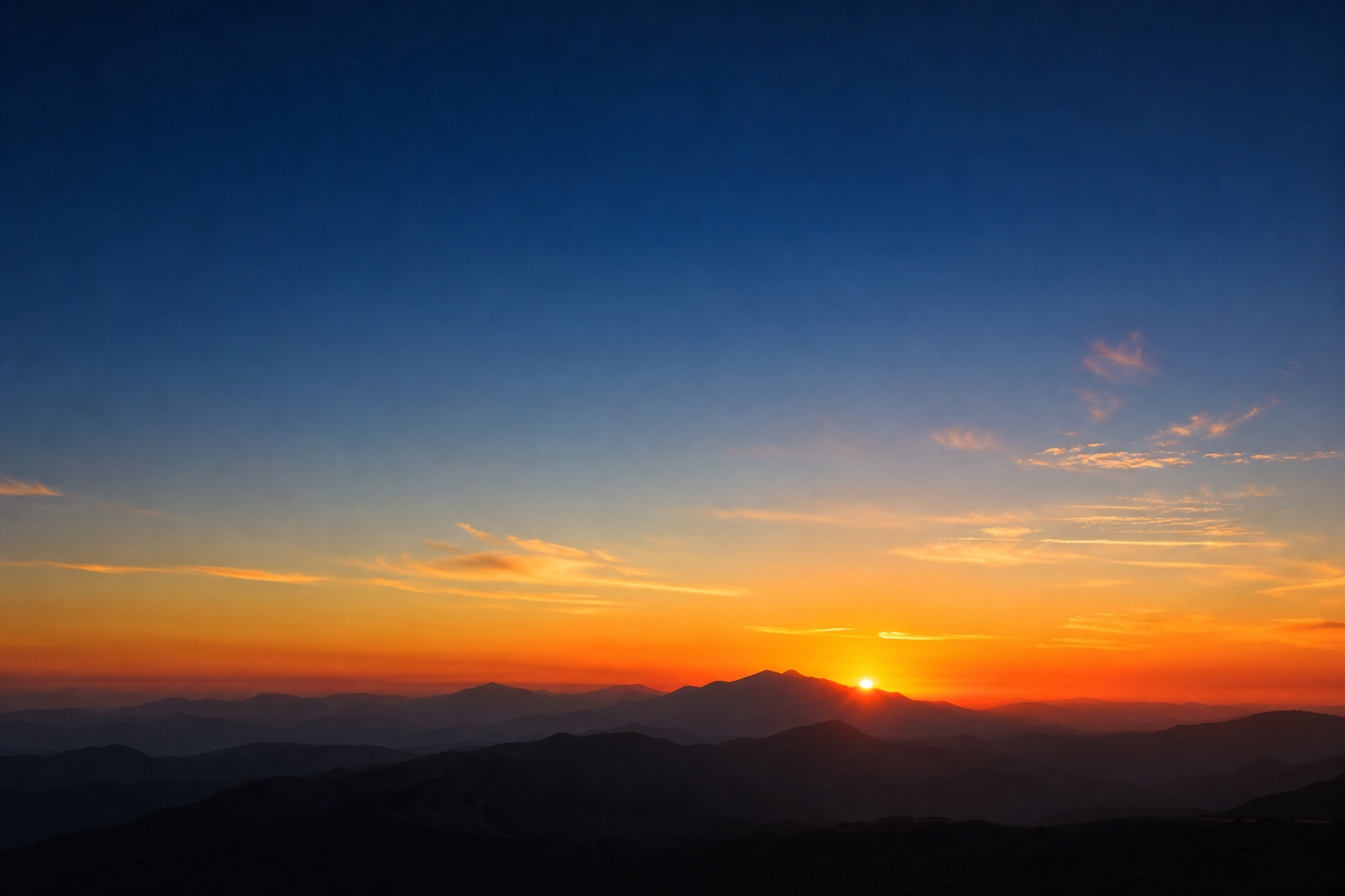 Physically based sky at golden hour with smooth orange-to-blue gradient over a distant mountain silhouette